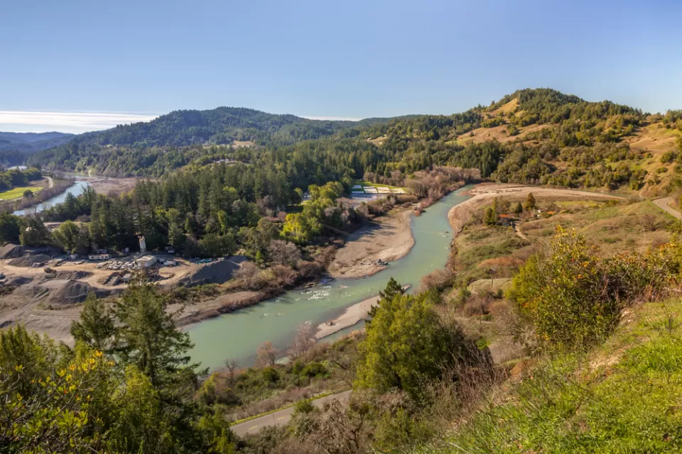 Aerial view of Eel River running through California forest
